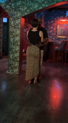 Couples dance bachata at neon-decorated Bangkok club Monday afternoon