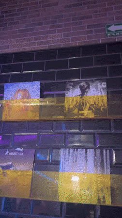 Colored light projections illuminate wall display in Puebla
