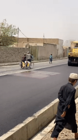 Road paving draws crowds in Kandahar neighborhood