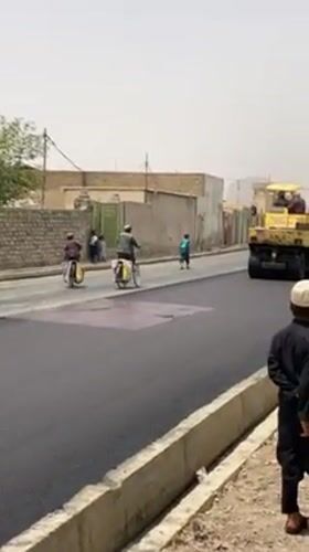 Road paving draws crowds in Kandahar neighborhood
