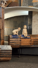 Baby sculptures with ginger hair displayed on pedestals in Moscow