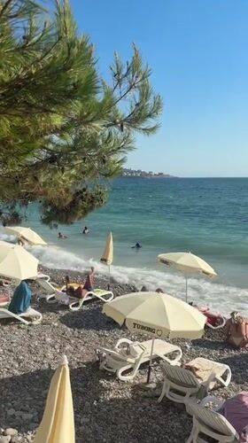 Crowded pebble beach day in Bar, Montenegro