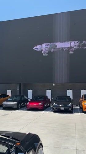 Teslas gather at West Hollywood LED display showing mixed content