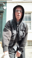 Elderly man in hooded jacket observed standing in London