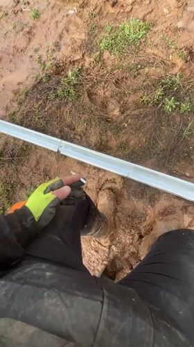Worker takes cigarette break in muddy Bulgarian field