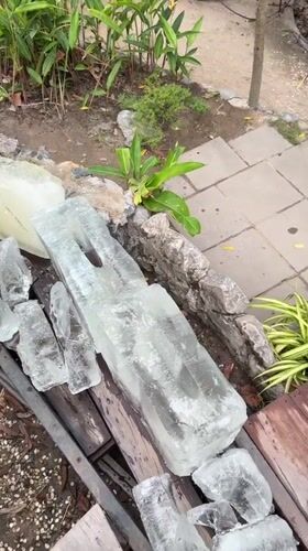 Ice blocks found on walkway in tropical Thailand setting