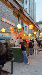 Evening market scene documented in Budapest with food stalls