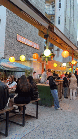 Evening market scene documented in Budapest with food stalls