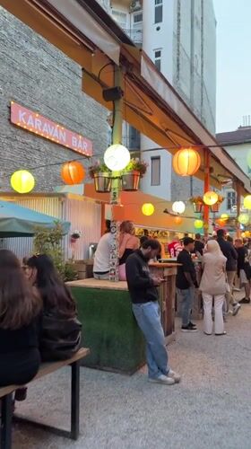 Evening market scene documented in Budapest with food stalls