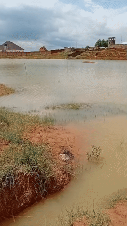Kids play in floodwaters surrounding buildings in rural Nigeria