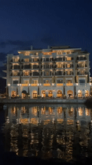 Tivat marina hotel glows at dusk, Montenegro waterfront