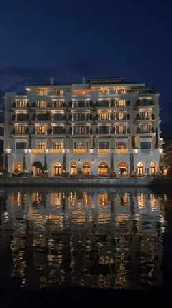 Tivat marina hotel glows at dusk, Montenegro waterfront