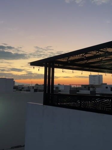 Sunset captured from Cholula rooftop with pergola and city view