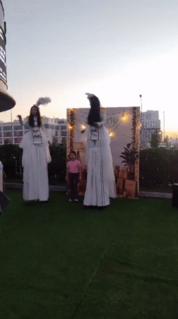 Outdoor festival evening in Astana with stilt performers and market stalls