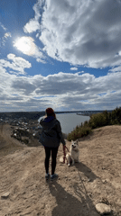 Woman and husky observed on hillside overlooking Russian town