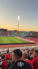 Football crowd fills Sofia stadium at sunset