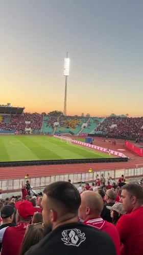 Football crowd fills Sofia stadium at sunset