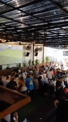 Sports bar crowd and calm beach morning in North Kuta