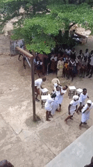 Outdoor gathering with dancing, ceremony, and crowd activity