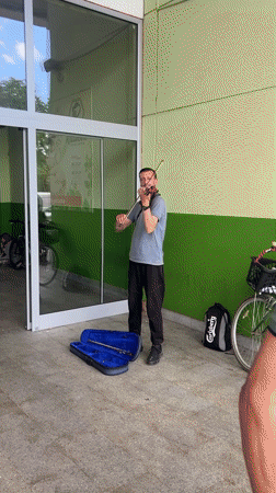 Street musician performs violin on Podgorica sidewalk