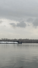 River traffic observed: cargo barge and named vessel cross waterway