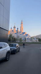 Toddler walks street near ornate church in Kazan