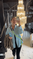 Woman takes selfies in upscale Moscow interior