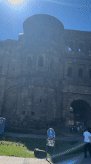 Tourists visit ancient Roman gate Porta Nigra in Trier