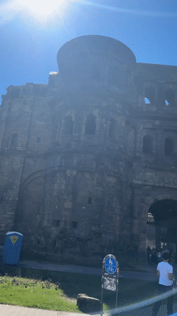 Tourists visit ancient Roman gate Porta Nigra in Trier