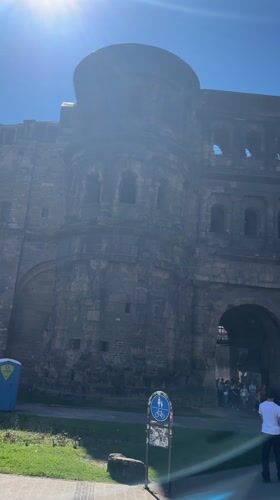 Tourists visit ancient Roman gate Porta Nigra in Trier