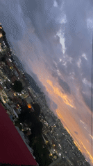 Dusk settles over Caracas hillsides amid dramatic cloudy skies