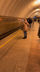 Commuter waits for train at Sankt-Peterburg subway station