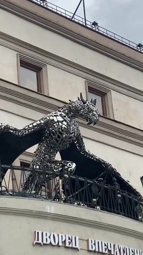 Ornate metal dragon sculpture perched on a Kazan building balcony