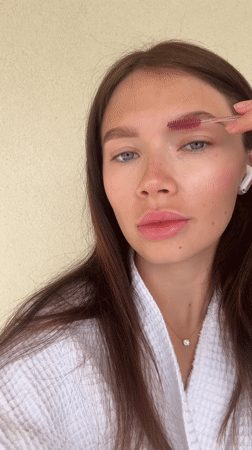 Woman does eyebrow grooming routine in Elliniko Greece
