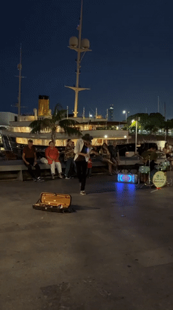 Street musicians perform evening waterfront concert in Barcelona