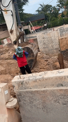 Roadside construction work underway in Ko Samui with heavy machinery