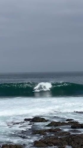 Bodyboarding and surfing session at Arica's rocky coastline