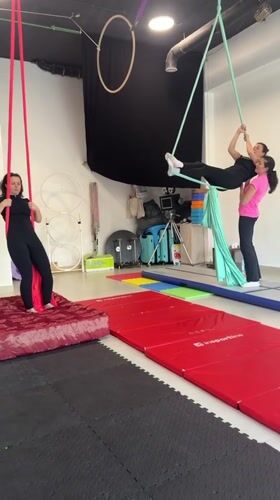 Women practice aerial silk acrobatics at Montenegro studio