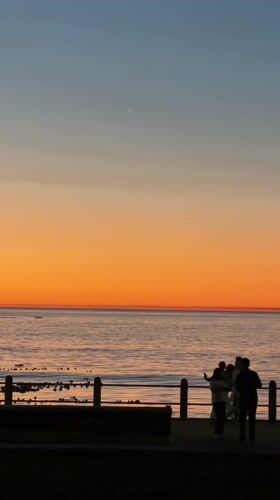 Cape Town residents gather for sunset viewing at waterfront
