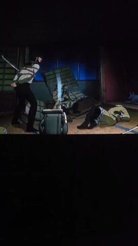 The video shows an anime scene depicting violence.  A man with a sword is standing over two men on the floor, one seated and one lying down, and a dog is nearby.  Close-ups of two men's faces are shown, both with blood and tears.