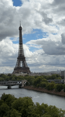 Eiffel Tower under a cloudy Paris sky