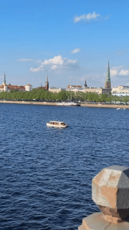 Tourist moments captured across Riga's historic riverfront and bridges