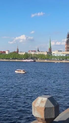 Tourist moments captured across Riga's historic riverfront and bridges