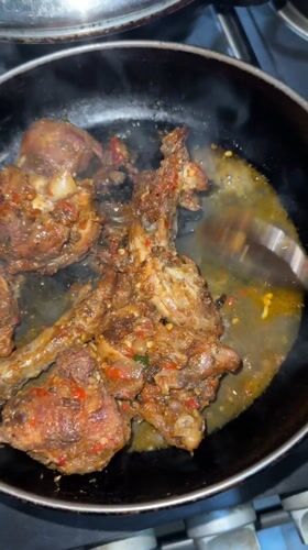 Spicy chicken dish prepared in Nigerian kitchen