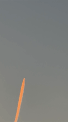 Orange contrail aircraft, crescent moon observed over Luxembourg morning