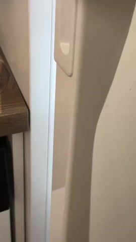 The video shows the inside of a refrigerator. On the top shelf, there is a plate of cheese and cherry tomatoes, as well as a container of what appears to be dessert and some jars. On the middle shelf, there is a large jar of what looks like tomato paste, a container of nuts, and several more containers of dessert. There is also some leafy green produce. On the bottom shelf, there are bananas, a cucumber, a carton of eggs, some cherry tomatoes, a slice of watermelon, and some other unidentifiable items. The refrigerator appears to be well-stocked with food.
