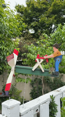 Wooden whirligig spotted on McLean fence displays chopping figure