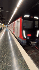 White and red train arrives at subway station