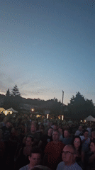 Evening concert in Hévíz with crowd gathered at outdoor stage