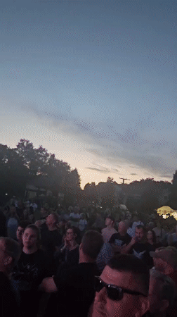 Evening concert in Hévíz with crowd gathered at outdoor stage